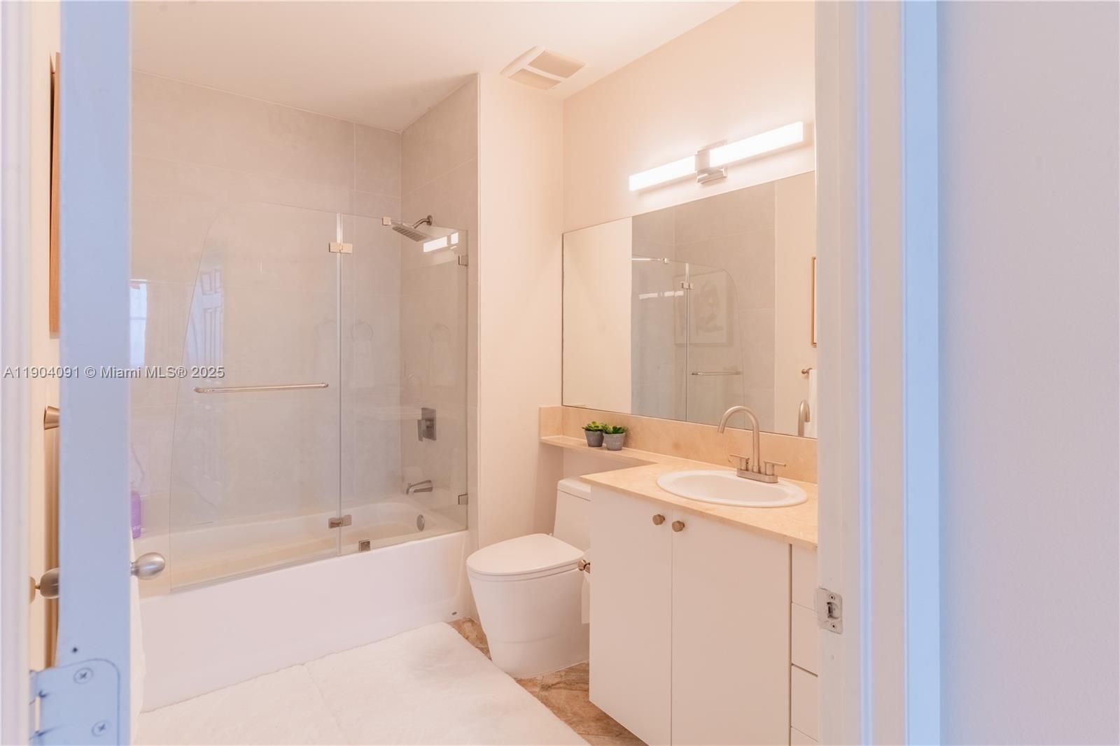 802 West Windward Way, Unit 411 Lantana, FL 33462 - Photo 28 of 42 a bathroom with a tub sink and mirror