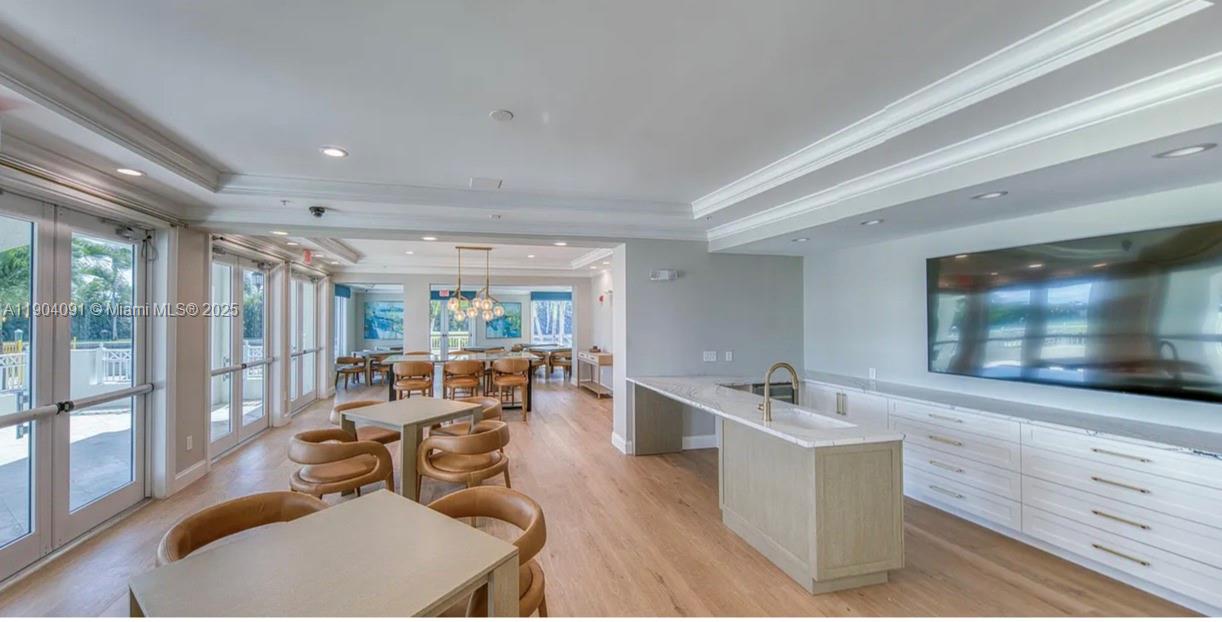 802 West Windward Way, Unit 411 Lantana, FL 33462 - Photo 33 of 42 a living room with furniture and a flat screen tv