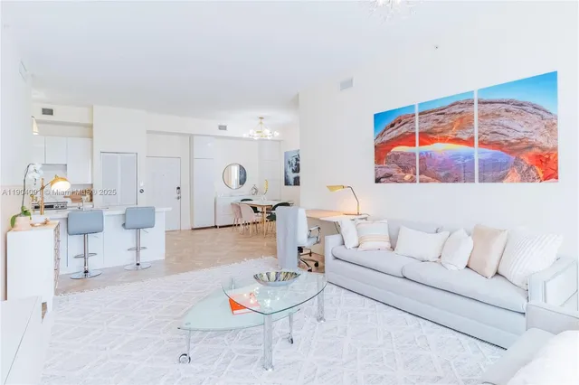 a living room with furniture and a floor to ceiling window