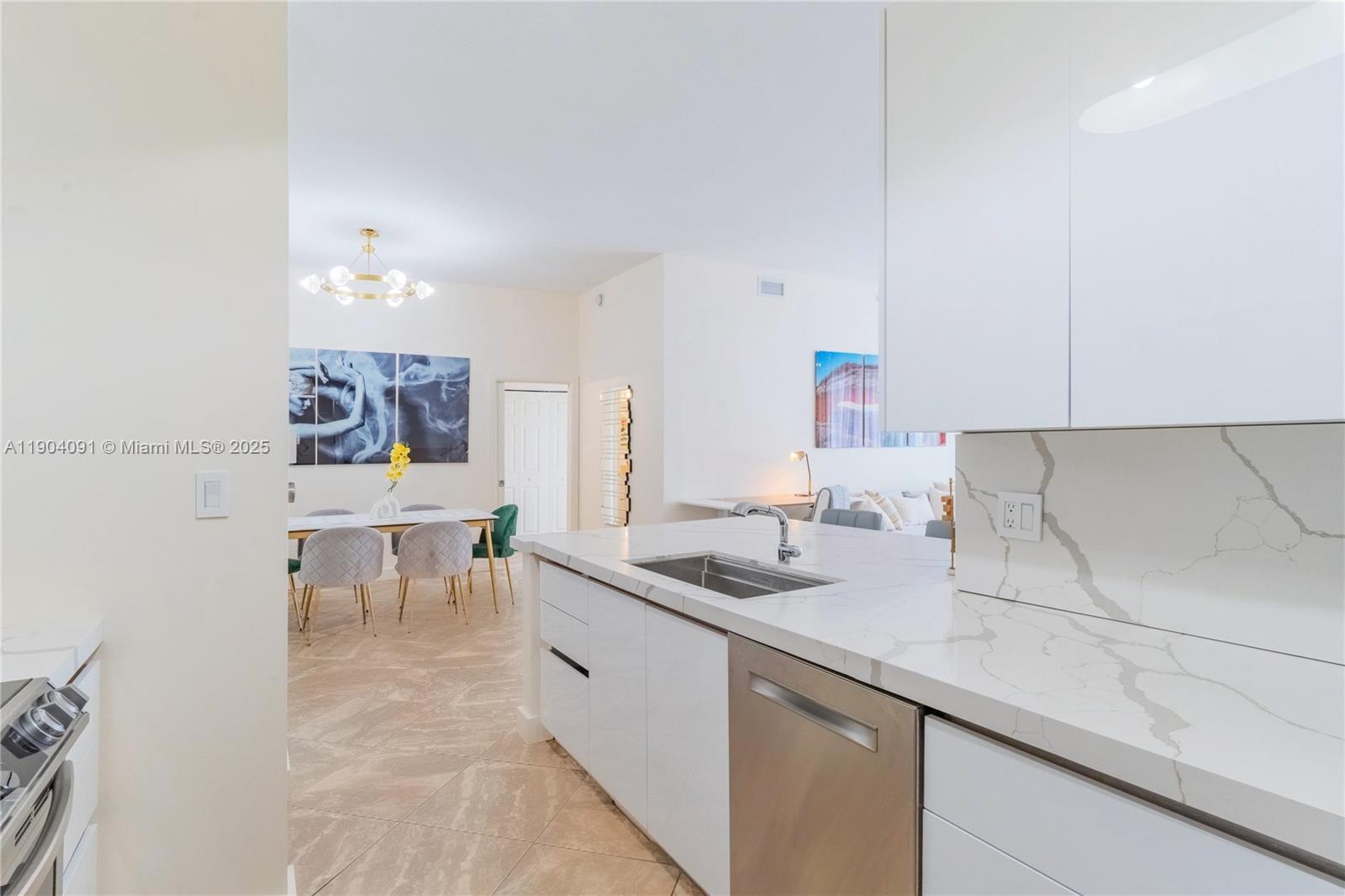 802 West Windward Way, Unit 411 Lantana, FL 33462 - Photo 10 of 42 a kitchen with a sink and chairs