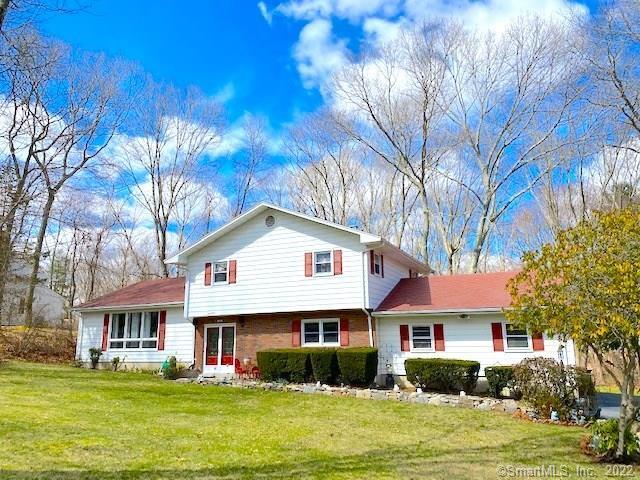 17 Trumbull Road Waterford, CT 06385 - Photo 1 of 1 a front view of a house with a garden and trees