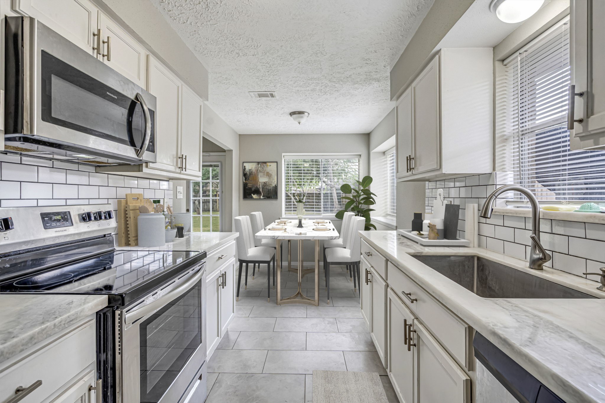 a kitchen that has a sink and a stove top oven