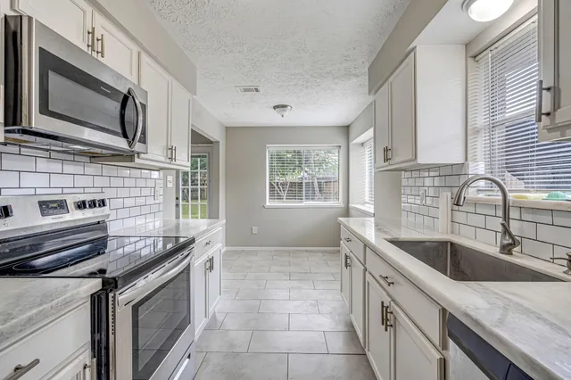 a kitchen that has a sink and a stove