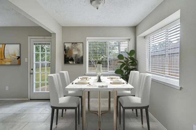 a dining room with furniture and window
