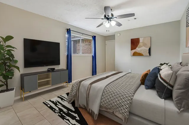 a bedroom with a bed and a flat screen tv