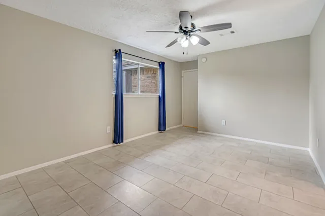 a view of a livingroom with a chandelier fan