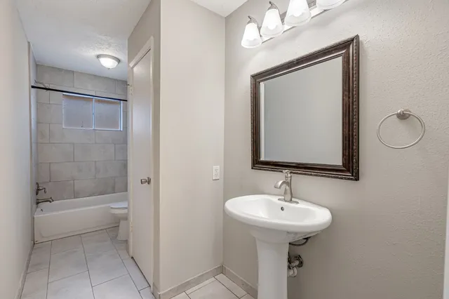 a bathroom with a sink a mirror and a bathtub