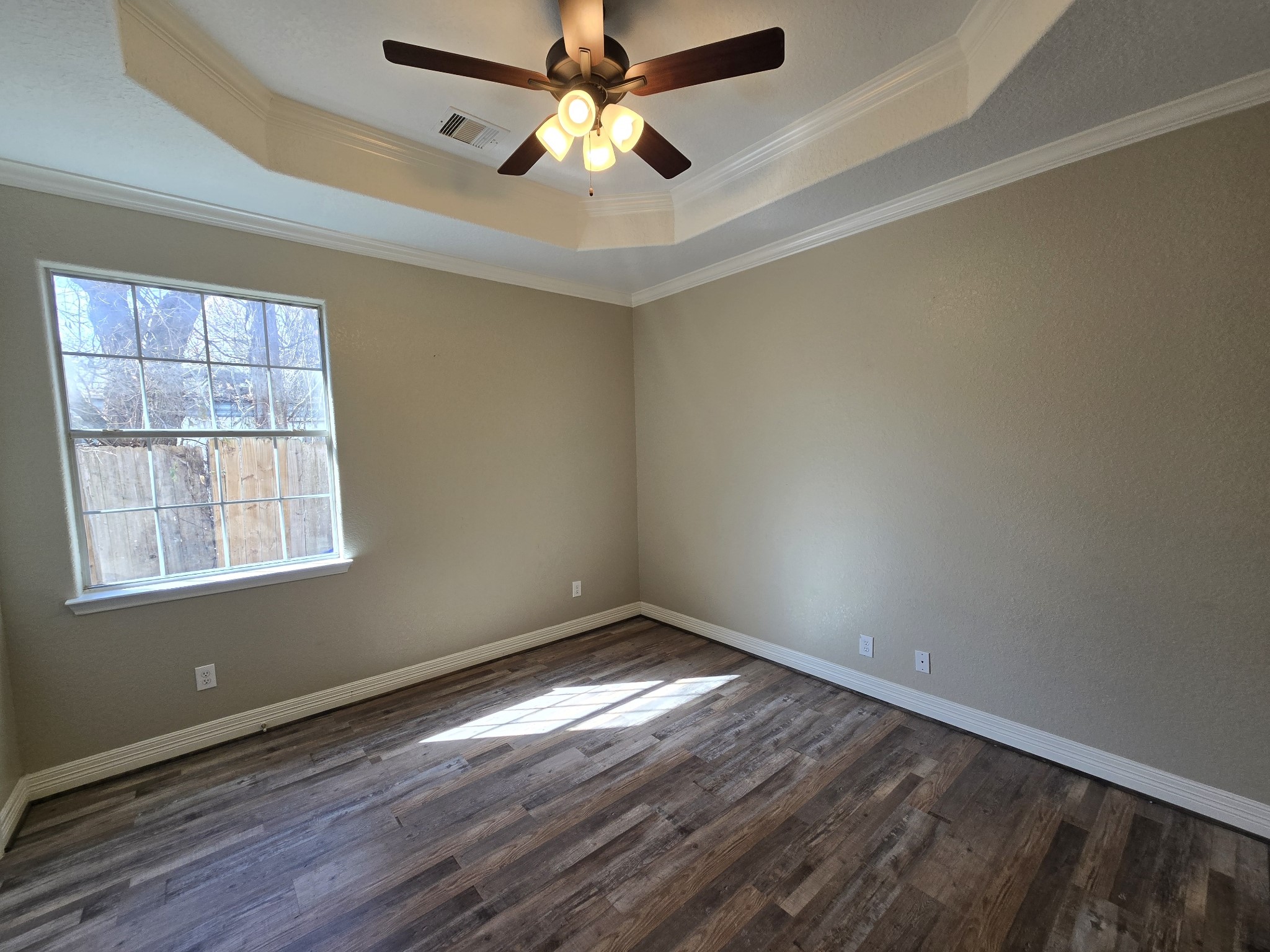 6324 Anderson Road, Unit A Houston, TX 77085 - Photo 5 of 18 an empty room with wooden floor fan and windows
