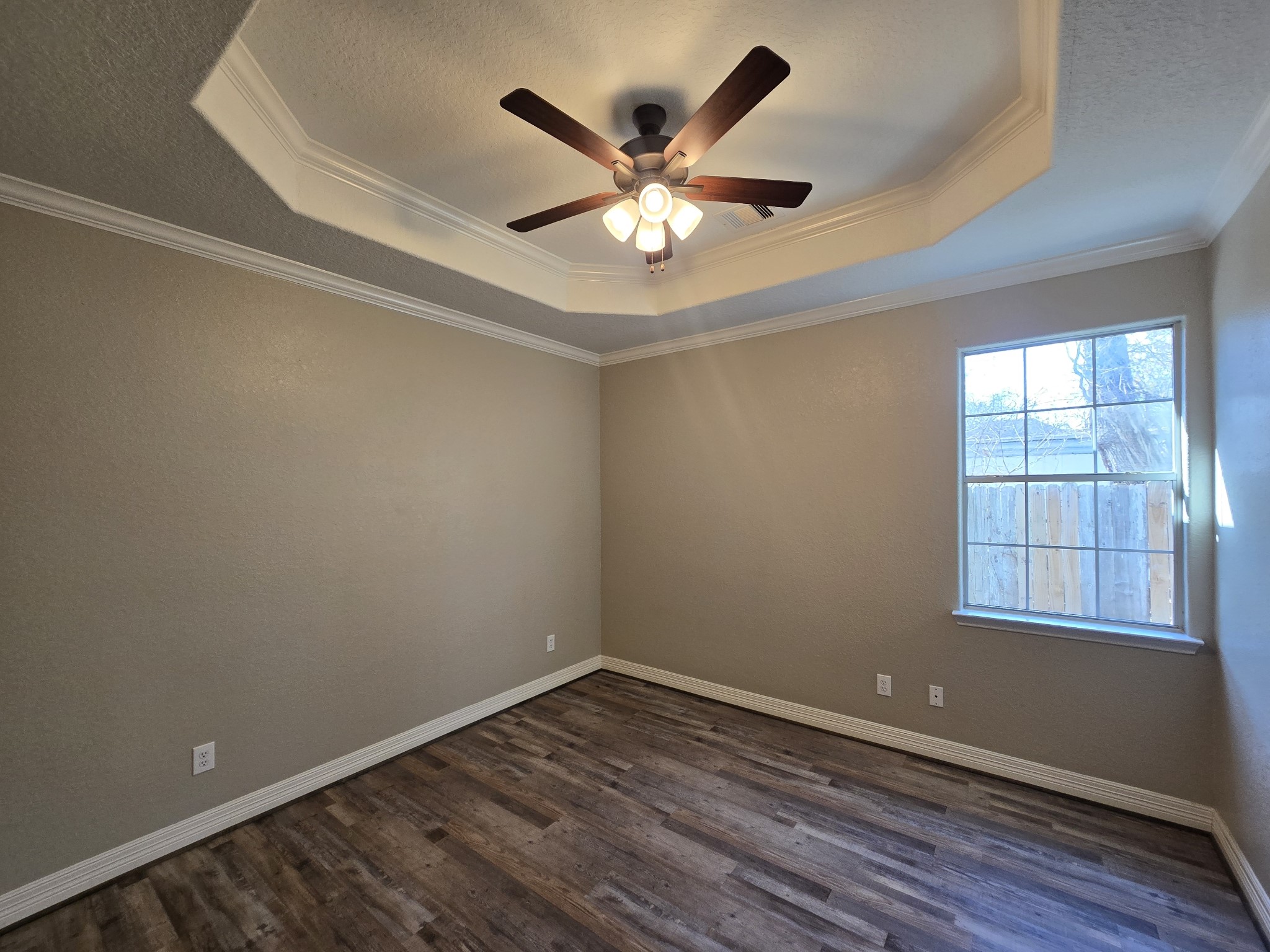 6324 Anderson Road, Unit A Houston, TX 77085 - Photo 8 of 18 an empty room with wooden floor fan and windows