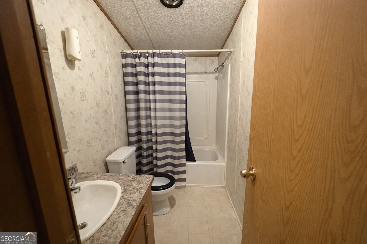 798 Williamson Road Tallapoosa, GA 30176 - Photo 70 of 73 a bathroom with a granite countertop sink and a mirror