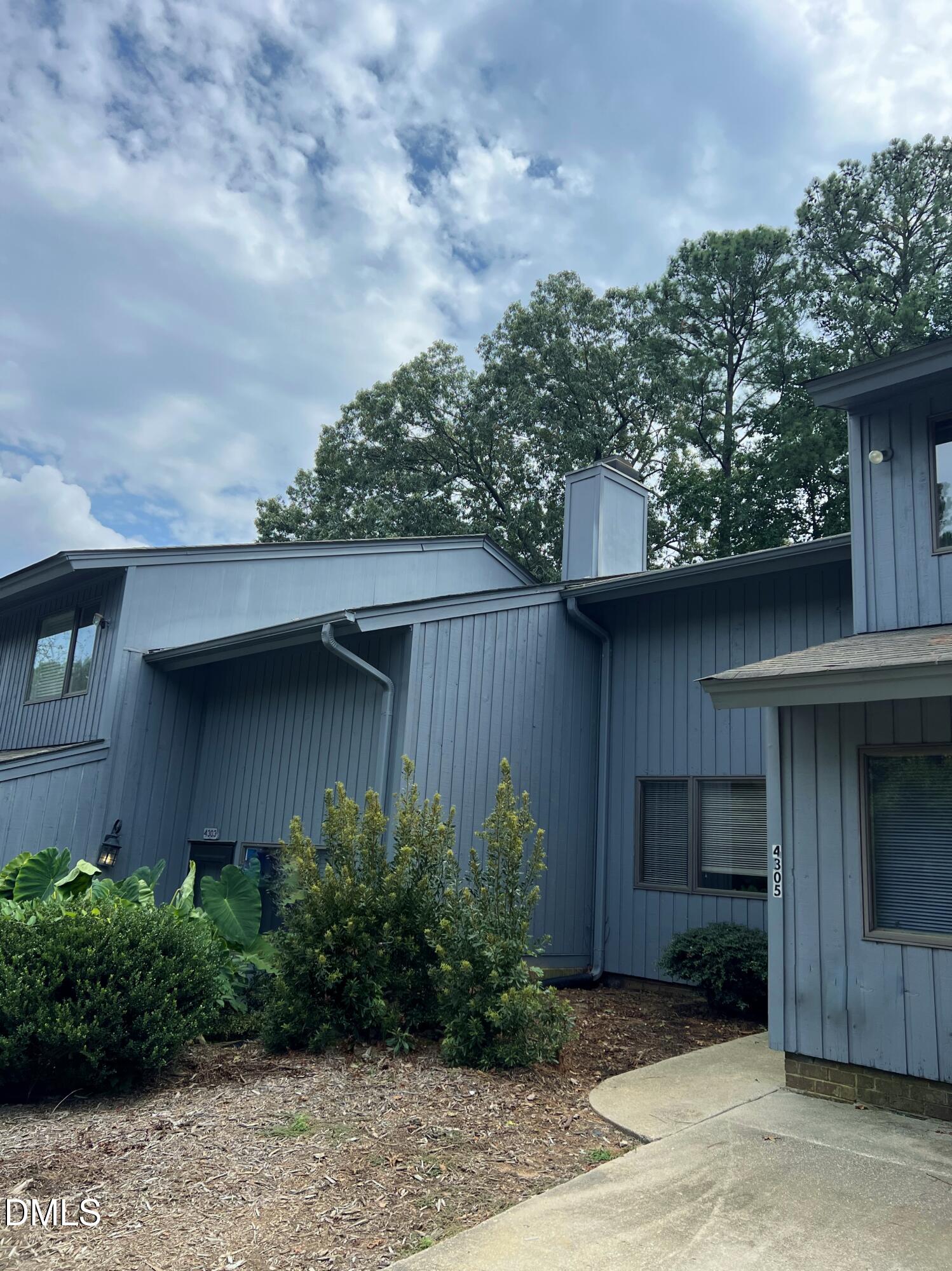 4305 Hunters Club Drive Raleigh, NC 27606 - Photo 1 of 12 a backyard of a house with plants and barbeque oven