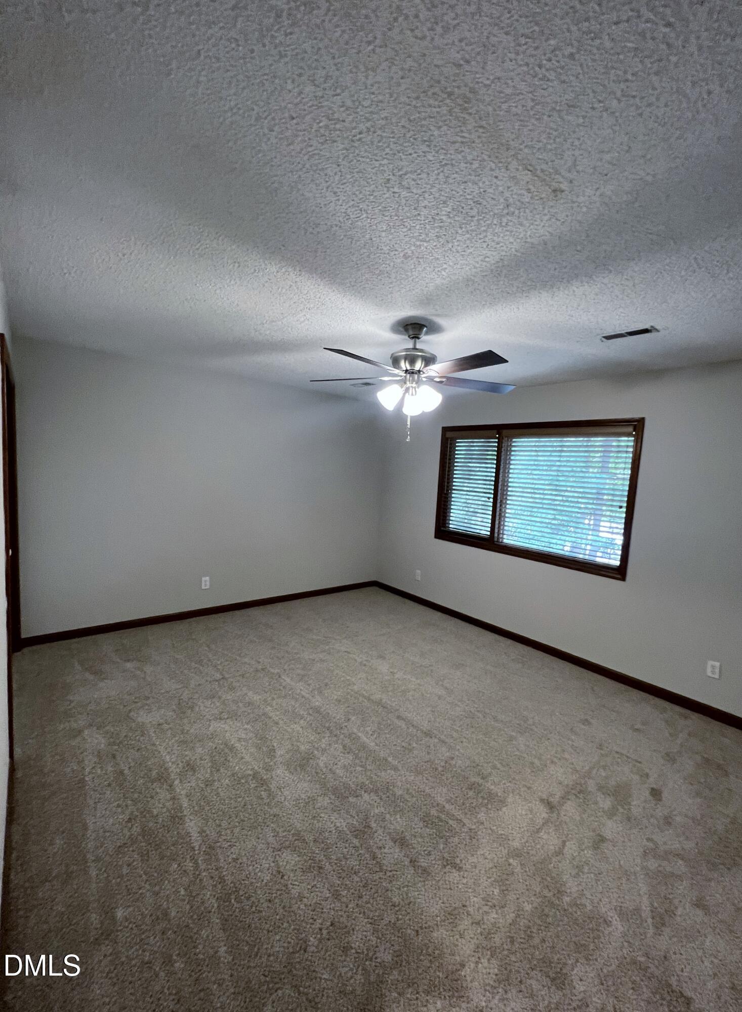 4305 Hunters Club Drive Raleigh, NC 27606 - Photo 11 of 12 an empty room with windows