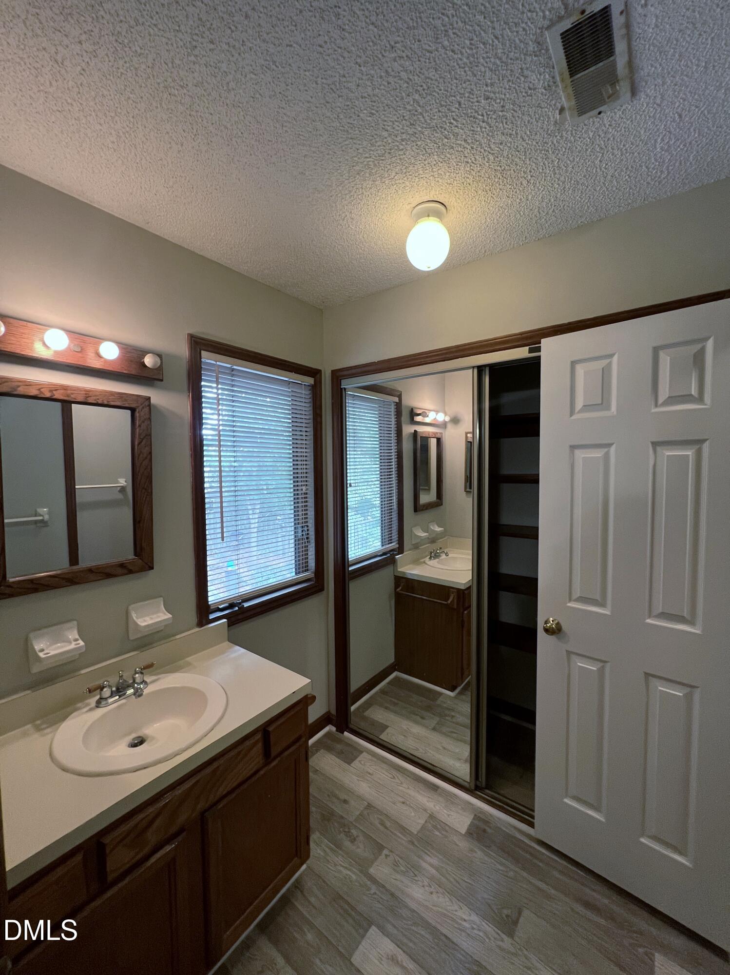 4305 Hunters Club Drive Raleigh, NC 27606 - Photo 12 of 12 a bathroom with a sink and a mirror