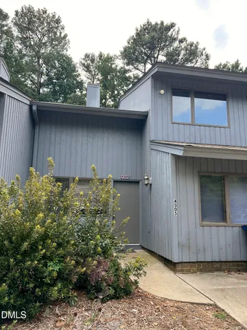 a house with trees in the background
