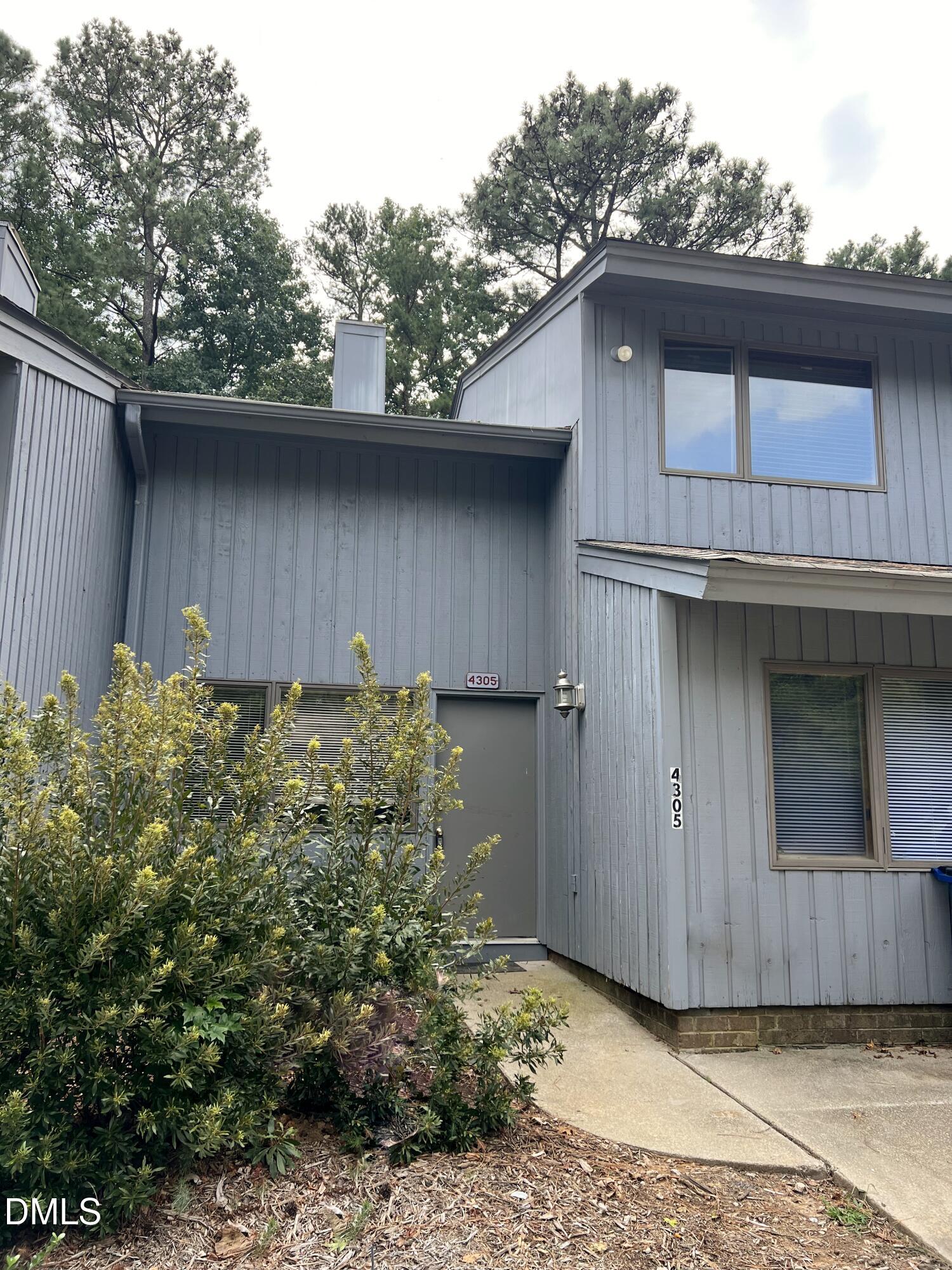 4305 Hunters Club Drive Raleigh, NC 27606 - Photo 2 of 12 a house with trees in the background