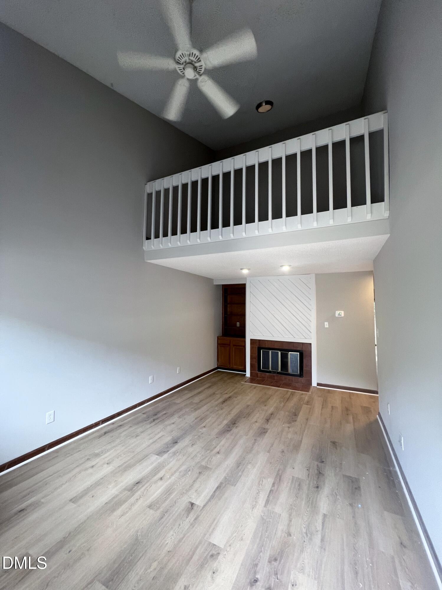 4305 Hunters Club Drive Raleigh, NC 27606 - Photo 3 of 12 a view of a livingroom with an empty space & a ceiling fan