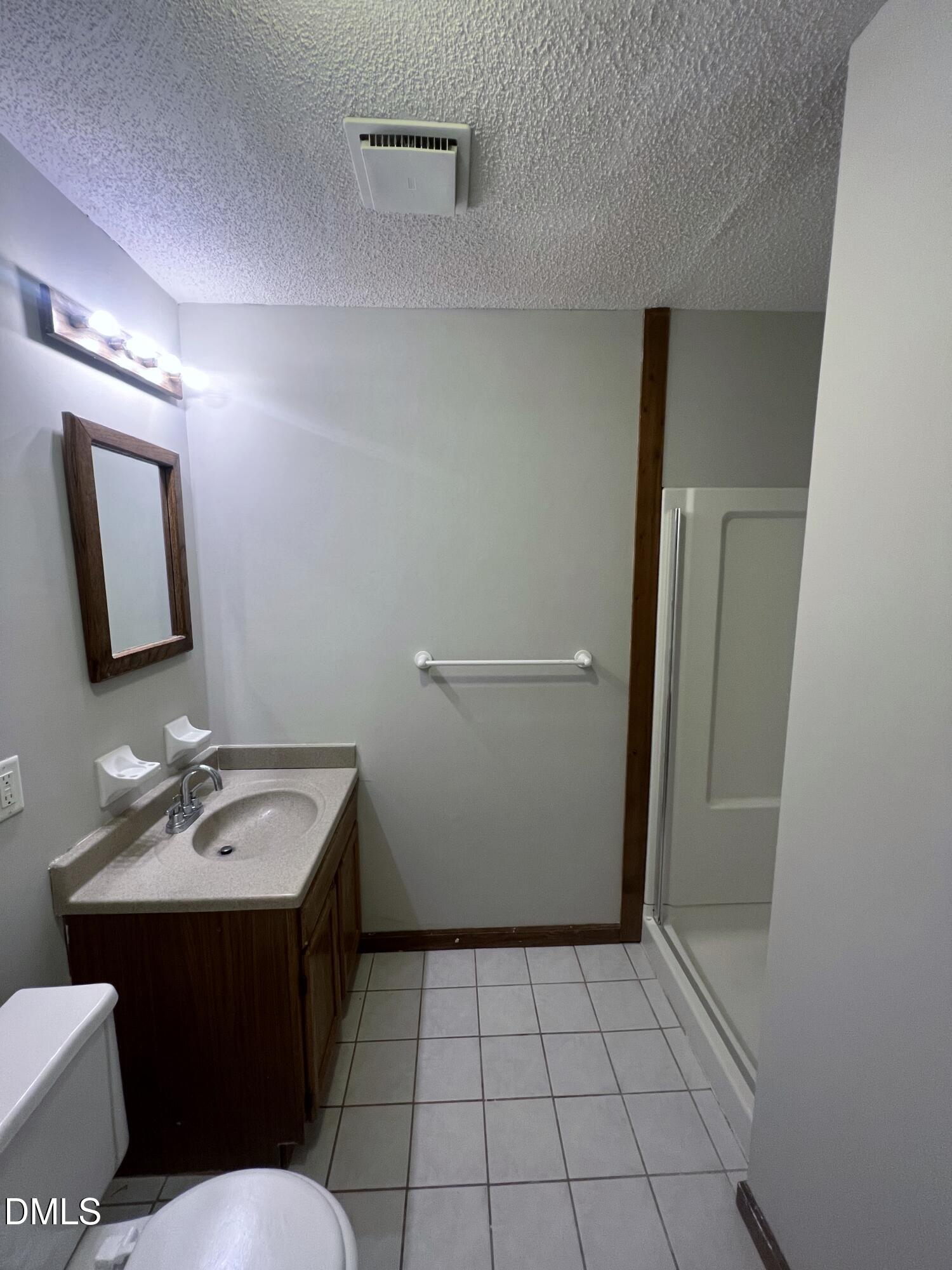 4305 Hunters Club Drive Raleigh, NC 27606 - Photo 7 of 12 a bathroom with a sink a toilet and mirror