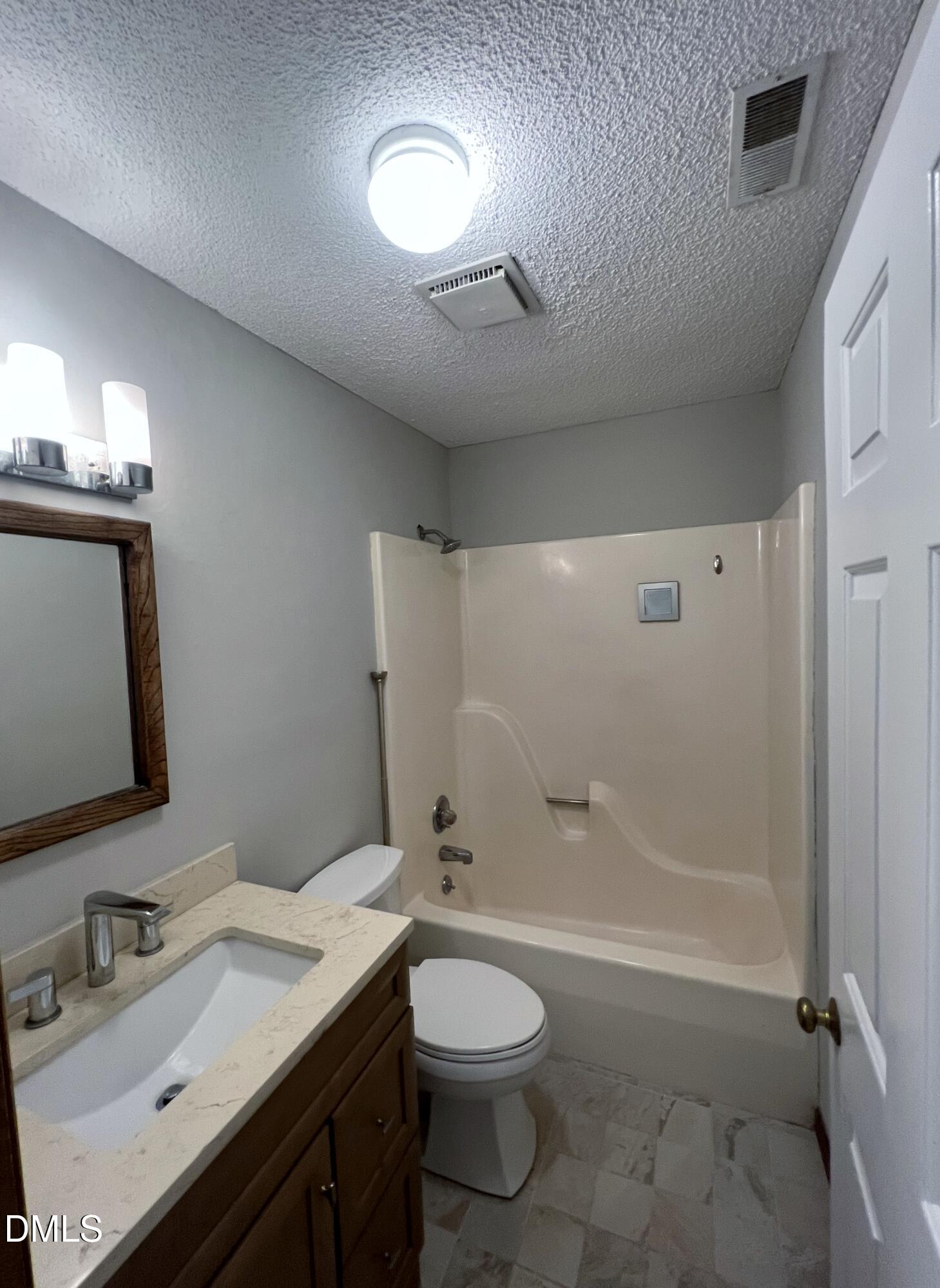 4305 Hunters Club Drive Raleigh, NC 27606 - Photo 9 of 12 a bathroom with a granite countertop sink toilet and shower