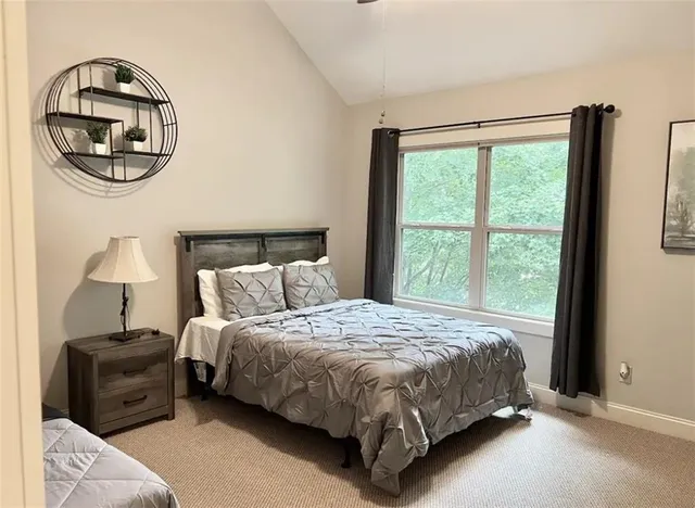 a bedroom with a bed and a mirror