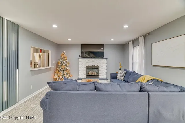 a living room with furniture and a fireplace
