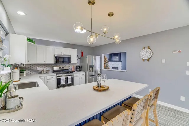 a kitchen with microwave a stove and refrigerator
