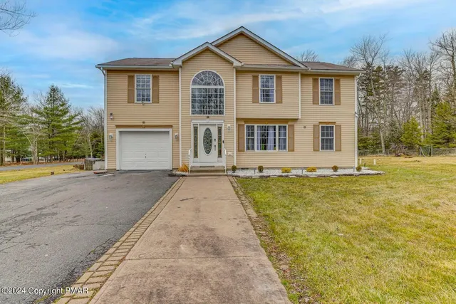a front view of a house with a yard
