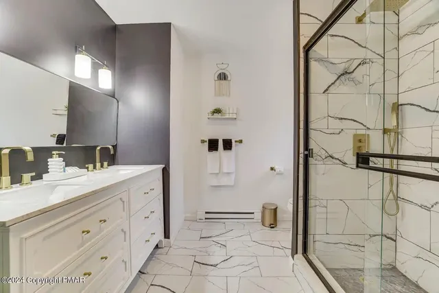 a bathroom with a double vanity sink mirror and shower