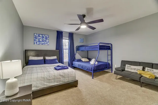 a bedroom with furniture and a large window