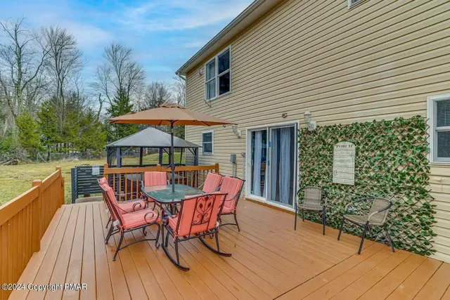 a patio with wooden floor and yard