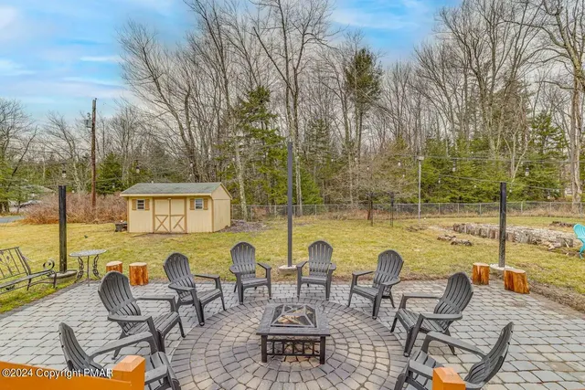 a view of a swimming pool with outdoor seating