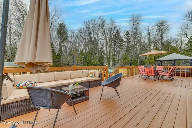 a view of a roof deck with furniture