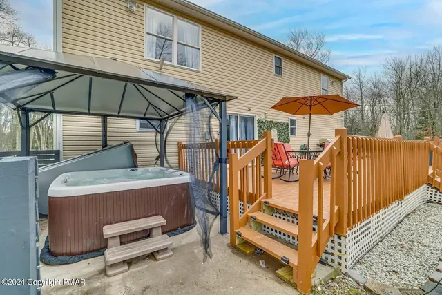 a view of a patio with table and chairs under an umbrella