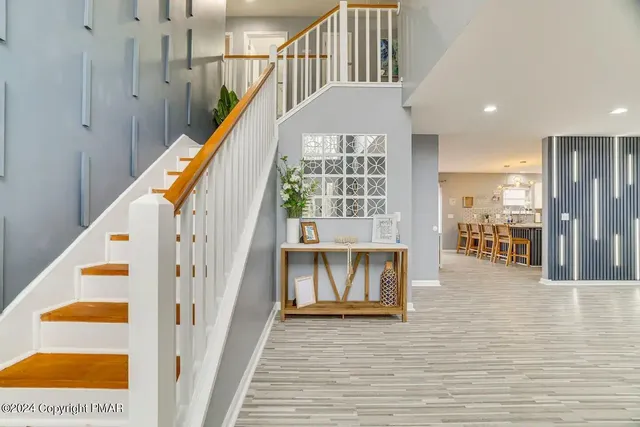 a view of entryway and hall with wooden floor