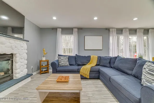 a living room with furniture and a fireplace