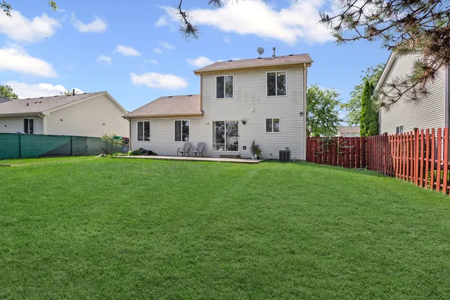 a front view of house with yard and green space