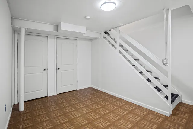 a view of an empty room with stairs