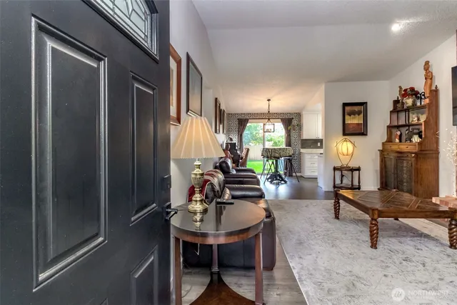 a living room with furniture a rug and a window