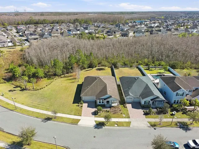 a view of swimming pool with outdoor seating and lake view