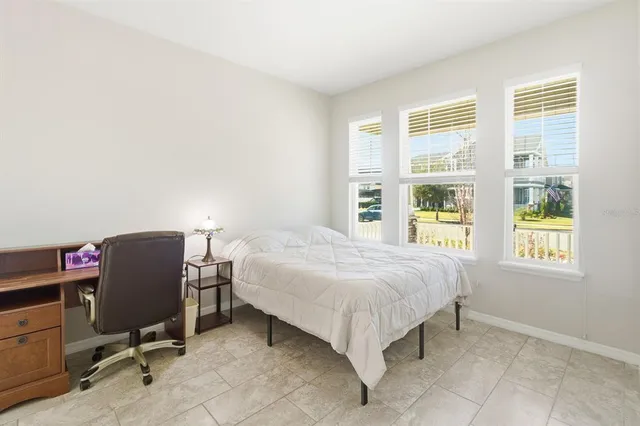 a bedroom with a bed chair and window