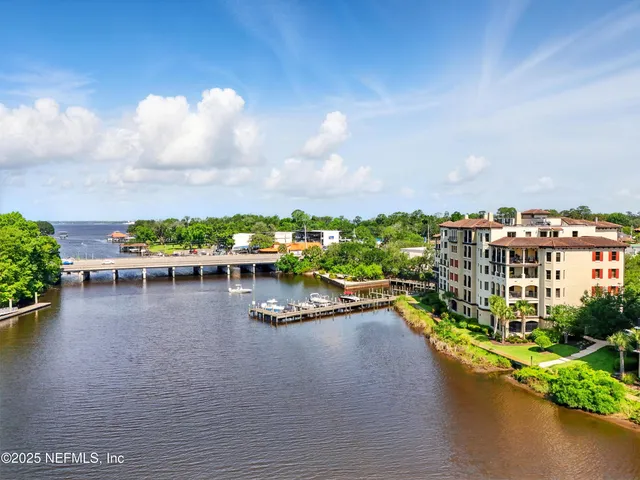 a view of a lake with a multi story building in front of it