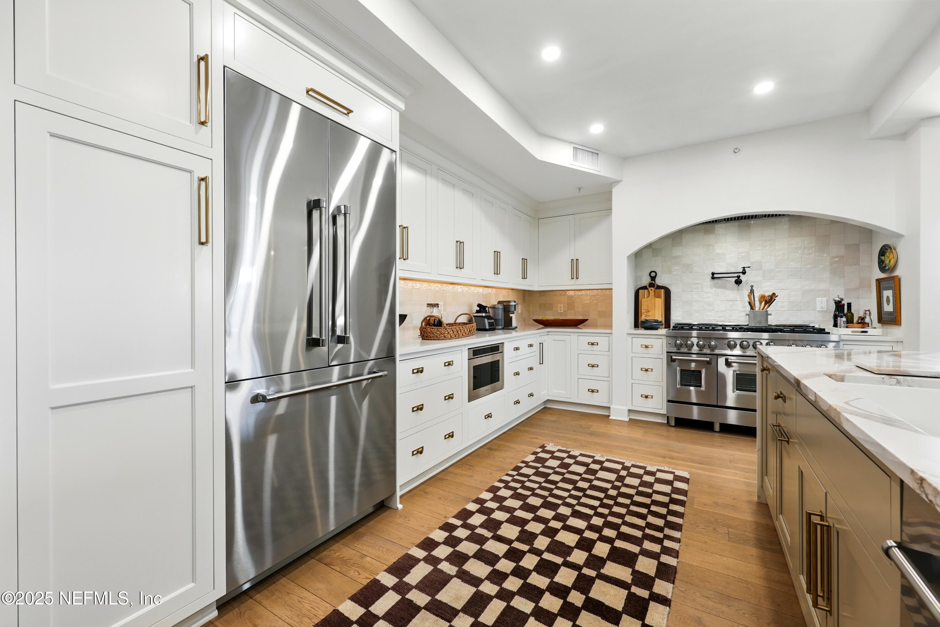 3958 Baymeadows Road, Unit 1602 Jacksonville, FL 32217 - Photo 14 of 89 a kitchen with stainless steel appliances a refrigerator and a stove top oven
