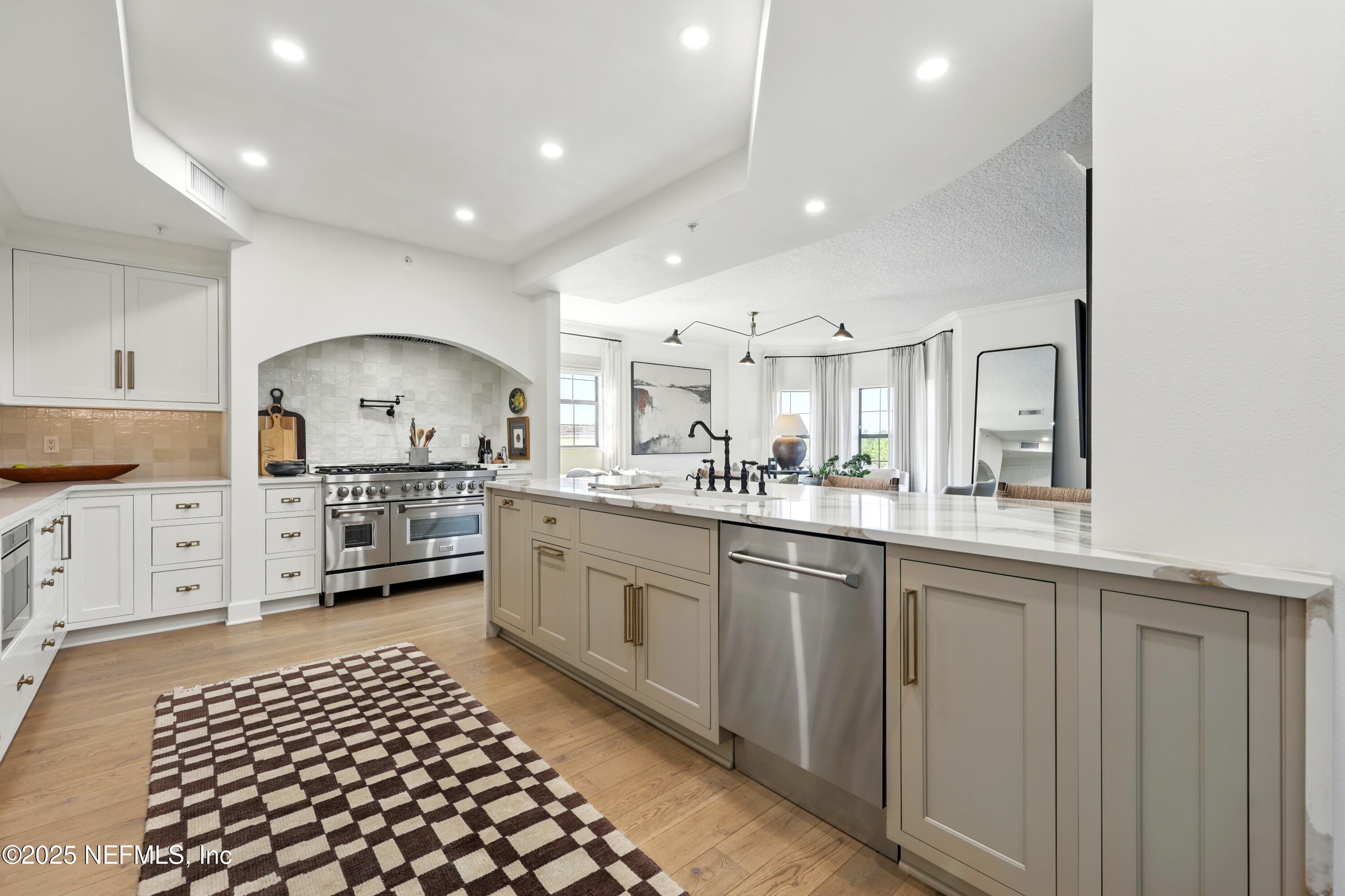 3958 Baymeadows Road, Unit 1602 Jacksonville, FL 32217 - Photo 16 of 89 a kitchen with stainless steel appliances a refrigerator sink and cabinets