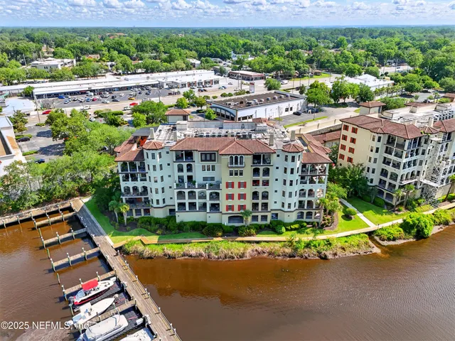 a kitchen with stainless steel appliances granite countertop a sink and a refrigerator