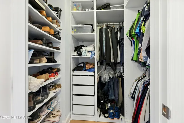 an aerial view of a house with a garden and lake view