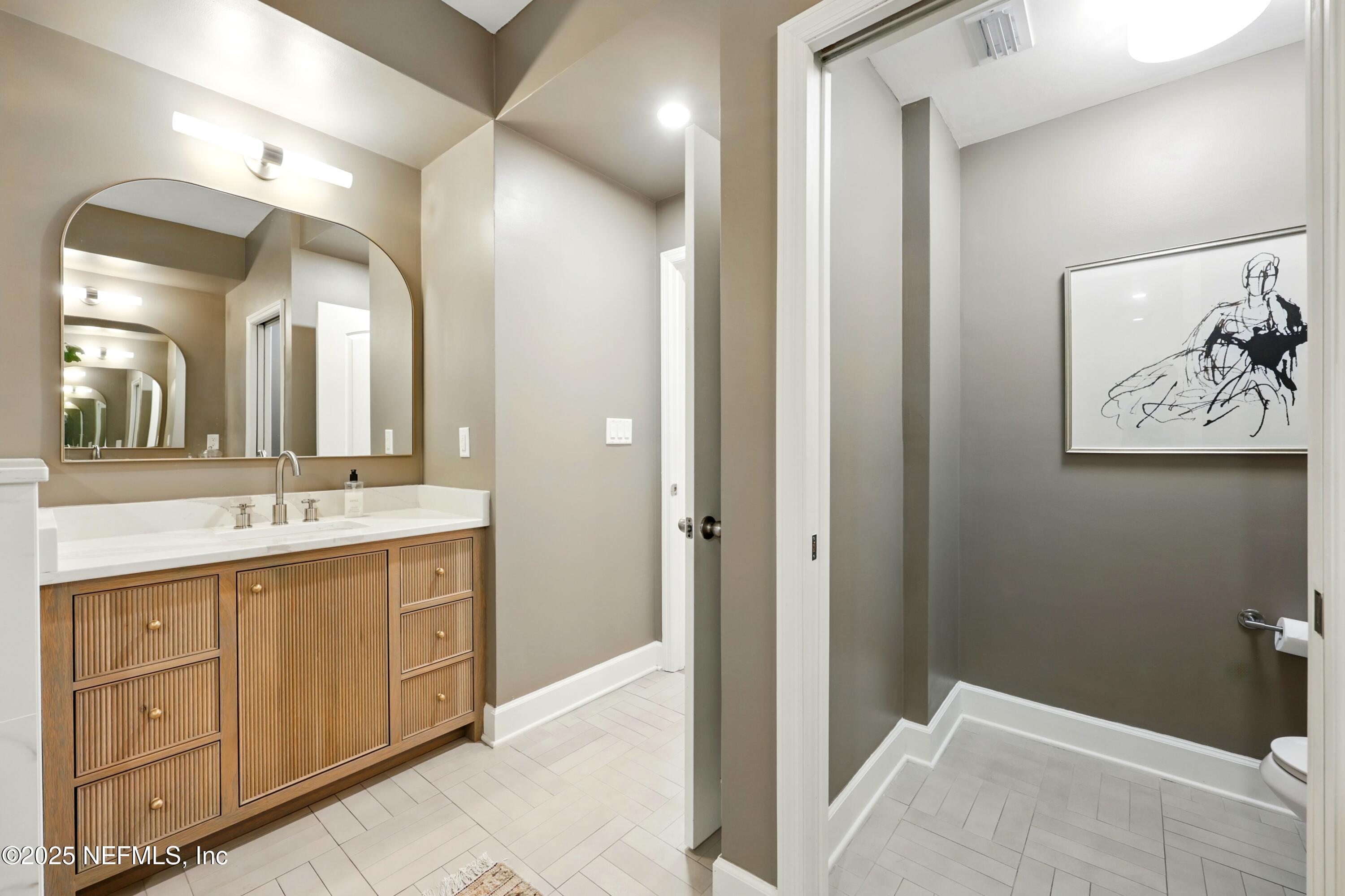 3958 Baymeadows Road, Unit 1602 Jacksonville, FL 32217 - Photo 36 of 89 a spacious bathroom with a double vanity sink and a mirror