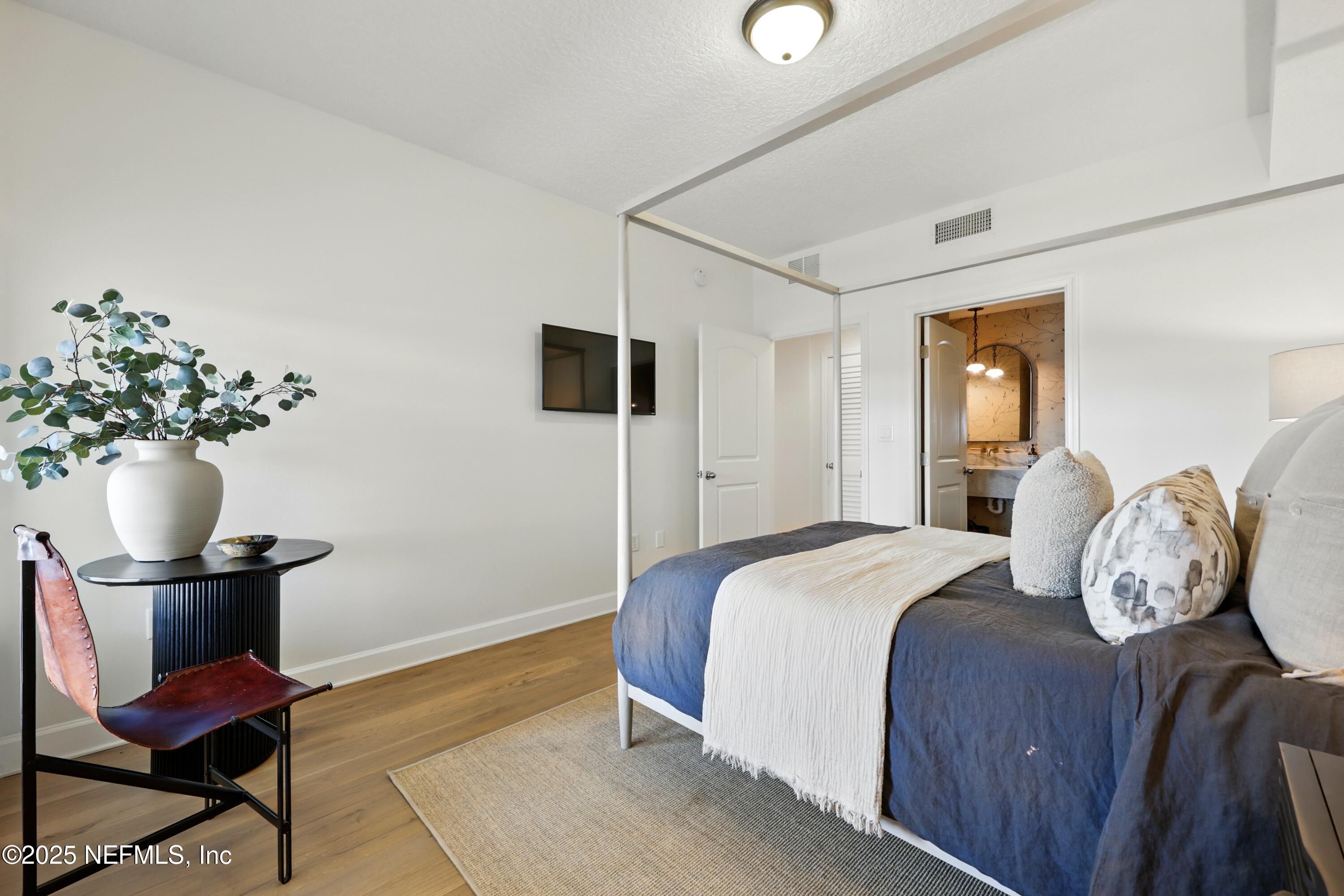 3958 Baymeadows Road, Unit 1602 Jacksonville, FL 32217 - Photo 38 of 89 a bedroom with a bed and a chair