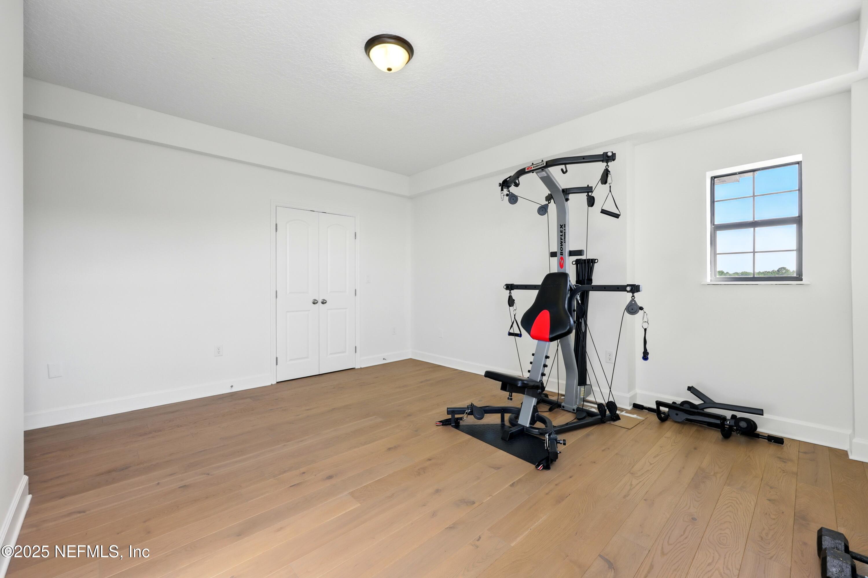 3958 Baymeadows Road, Unit 1602 Jacksonville, FL 32217 - Photo 42 of 89 a room with gym equipment and a window