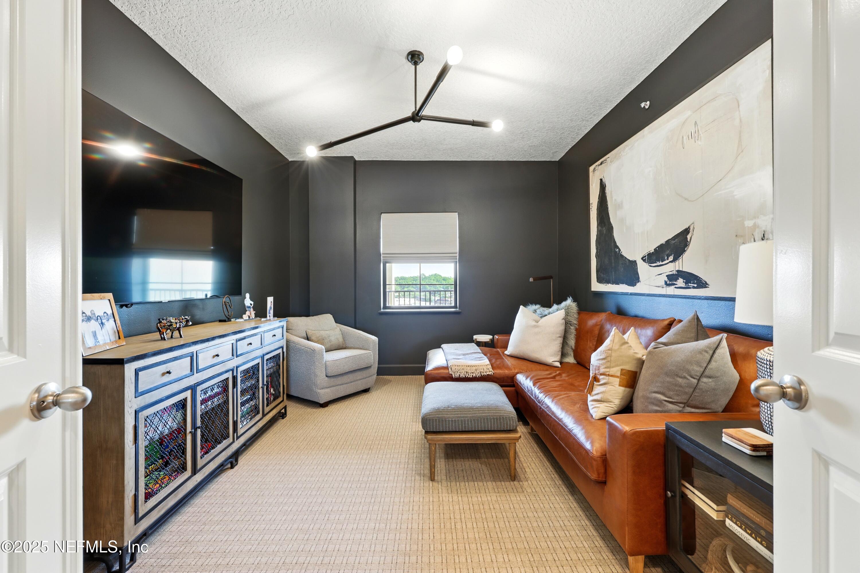 3958 Baymeadows Road, Unit 1602 Jacksonville, FL 32217 - Photo 47 of 89 a living room with furniture and a flat screen tv