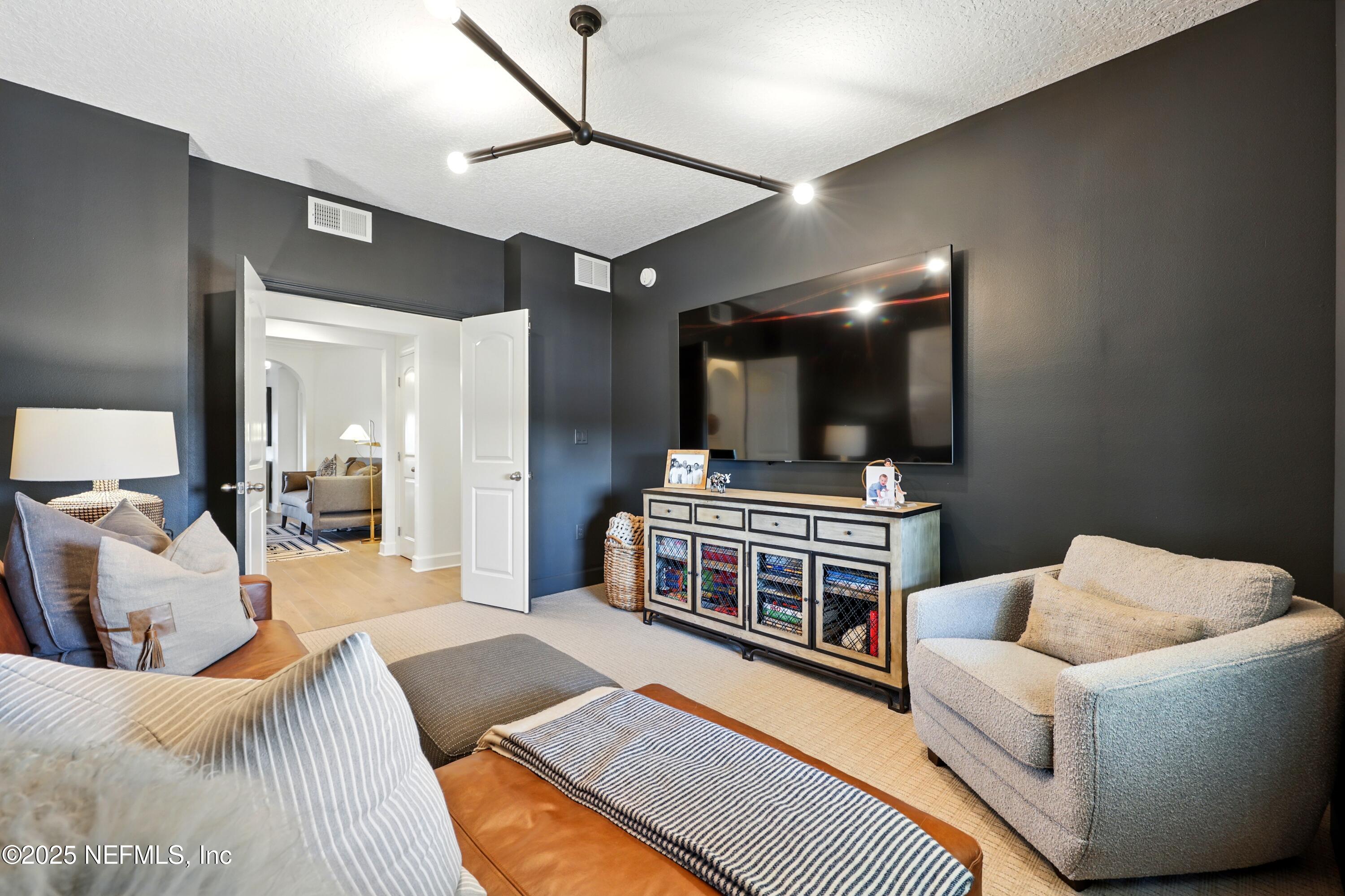 3958 Baymeadows Road, Unit 1602 Jacksonville, FL 32217 - Photo 48 of 89 a bedroom with a bed and a flat screen tv