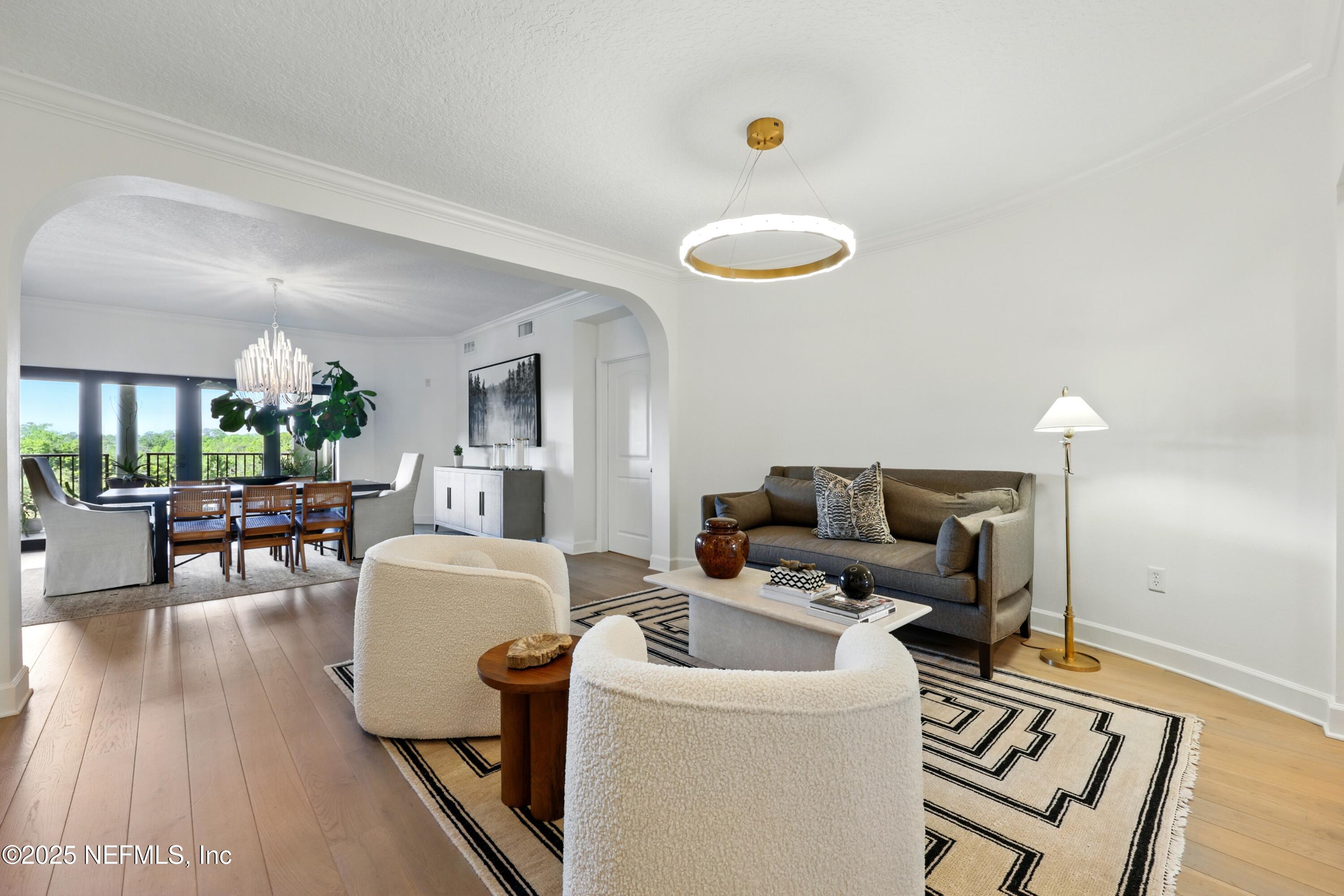 3958 Baymeadows Road, Unit 1602 Jacksonville, FL 32217 - Photo 7 of 89 a living room with furniture and a wooden floor